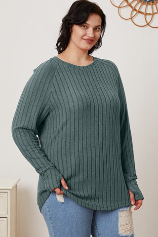Woman wearing a Basic Bae ribbed thumbhole sleeve t-shirt in teal, paired with ripped jeans.
