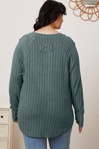 Woman wearing Basic Bae Full Size Ribbed Thumbhole Sleeve T-Shirt in green, back view, showcasing ribbed texture and long sleeves.