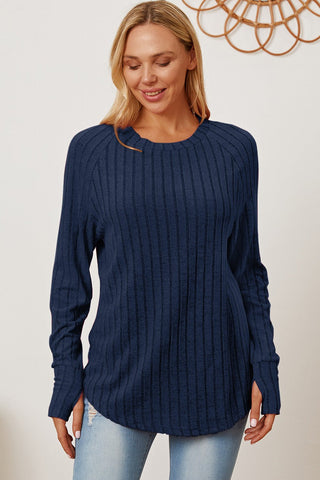 Woman wearing a navy ribbed thumbhole sleeve t-shirt, featuring a slightly stretchy fit, ideal for casual styles.