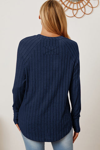 Woman wearing navy ribbed thumbhole sleeve T-shirt from Basic Bae, showcasing back design and casual fit.