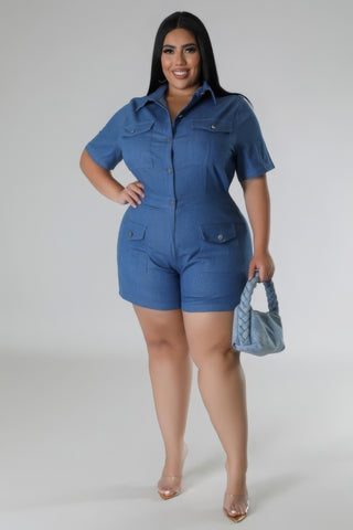 Woman wearing a blue semi-stretch romper with collar, short sleeves, and pockets, holding a matching handbag, showcasing plus size fashion.