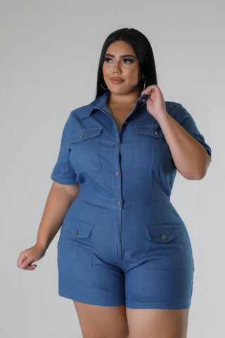 Plus-size semi-stretch romper in blue with a collar, short sleeves, and pockets, available in sizes 1XL to 3XL, featuring button closure.