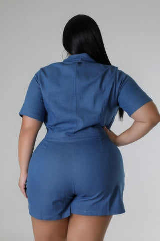 Plus-size model wearing a blue semi-stretch romper with short sleeves and collar, showcasing back design and comfortable fit.