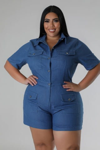 Plus-size woman in blue semi-stretch romper with collar, short sleeves, pockets, and button closure.