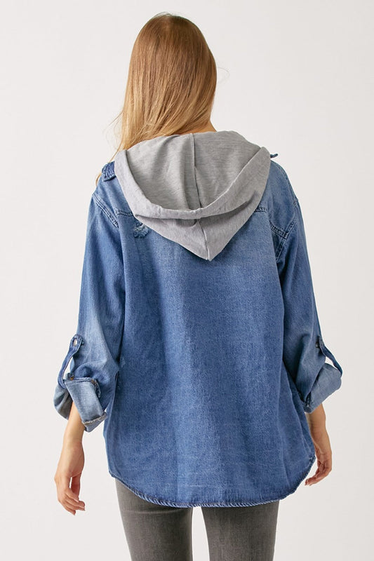 Woman wearing washed zip-up hooded denim shirt with pockets, back view showcasing slightly stretchy 100% cotton material